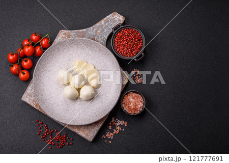 Delicious fresh mozzarella cheese with tomatoes, salt and spices Delicious fresh mozzarella cheese with tomatoes, salt and spices 121777691