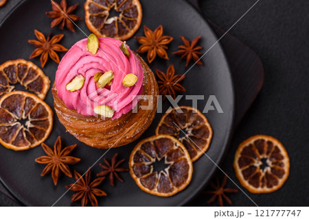 Sweet craffin or panettone garnished with raspberry and pistachio flavored cream Sweet craffin or panettone garnished with raspberry and pistachio flavored cream 121777747