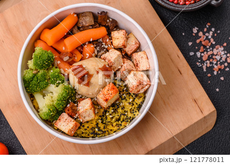 Colorful vegan vegetarian dish consists of tofu, broccoli, quinoa, mushrooms 121778011