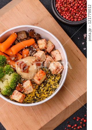 Colorful vegan vegetarian dish consists of tofu, broccoli, quinoa, mushrooms 121778012