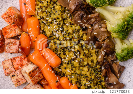 Colorful vegan vegetarian dish consists of tofu, broccoli, quinoa, mushrooms 121778028