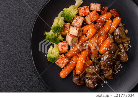 Colorful vegan vegetarian dish consists of tofu, broccoli, quinoa, mushrooms 121778034