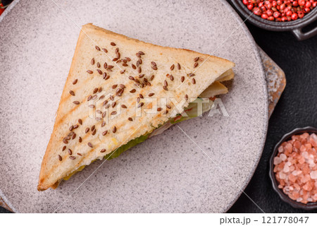 Sandwich with toast bread, meat, tomatoes, cheese, sauce, salt and spices 121778047