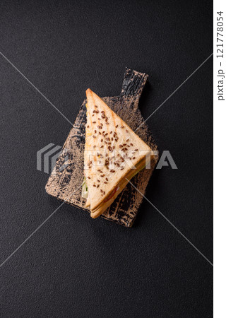Sandwich with toast bread, meat, tomatoes, cheese, sauce, salt and spices Sandwich with toast bread, meat, tomatoes, cheese, sauce, salt and spices 121778054