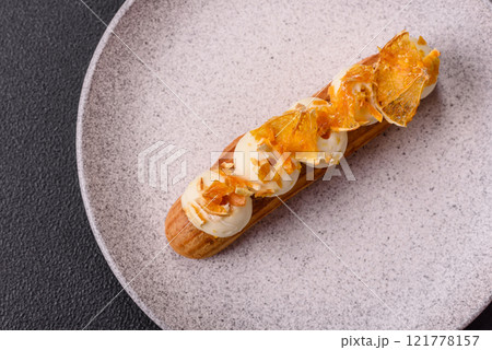 Sweet dessert eclairs or profiteroles with chocolate filling Sweet dessert eclairs or profiteroles with chocolate filling 121778157