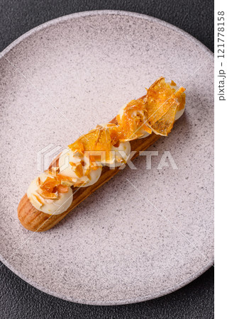 Sweet dessert eclairs or profiteroles with chocolate filling Sweet dessert eclairs or profiteroles with chocolate filling 121778158