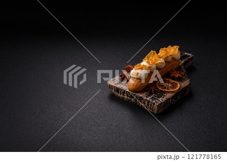 Sweet dessert eclairs or profiteroles with chocolate filling 121778165