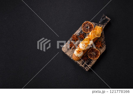 Sweet dessert eclairs or profiteroles with chocolate filling 121778166