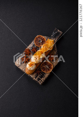 Sweet dessert eclairs or profiteroles with chocolate filling 121778167