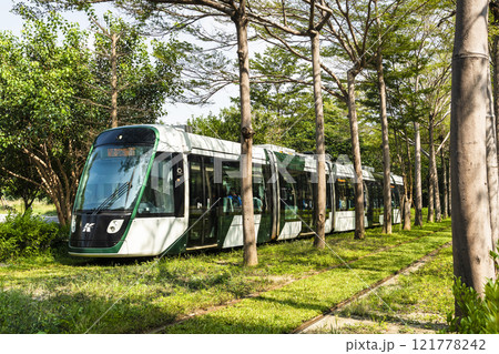 The circular light rail train drives past the Kaohsiung Museum of Fine Arts station in Taiwan. 121778242