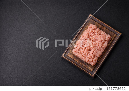 Fresh raw chicken mince with salt, spices and herbs Fresh raw chicken mince with salt, spices and herbs 121778622