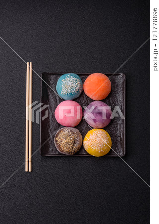 Delicious colorful asian mochi sweets with rice dough shell and fruit filling 121778896