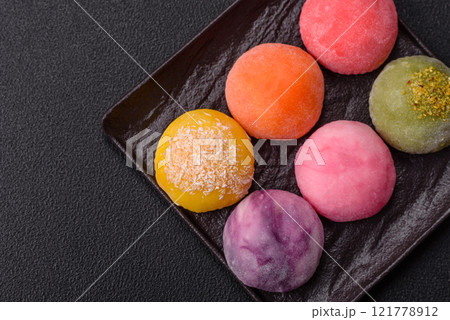 Delicious colorful asian mochi sweets with rice dough shell and fruit filling Delicious colorful asian mochi sweets with rice dough shell and fruit filling 121778912