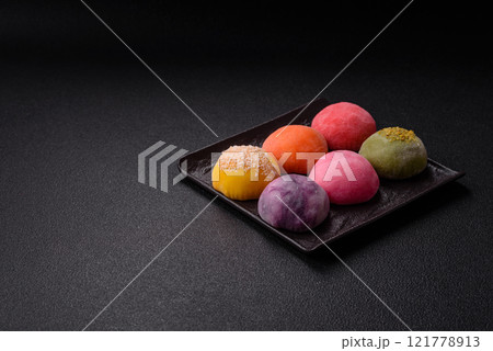 Delicious colorful asian mochi sweets with rice dough shell and fruit filling Delicious colorful asian mochi sweets with rice dough shell and fruit filling 121778913