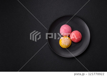 Delicious colorful asian mochi sweets with rice dough shell and fruit filling Delicious colorful asian mochi sweets with rice dough shell and fruit filling 121778922