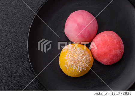 Delicious colorful asian mochi sweets with rice dough shell and fruit filling Delicious colorful asian mochi sweets with rice dough shell and fruit filling 121778925