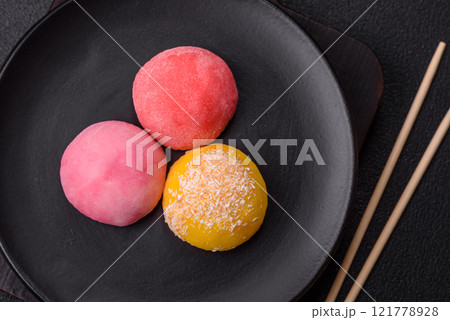 Delicious colorful asian mochi sweets with rice dough shell and fruit filling 121778928
