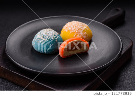 Delicious colorful asian mochi sweets with rice dough shell and fruit filling 121778939