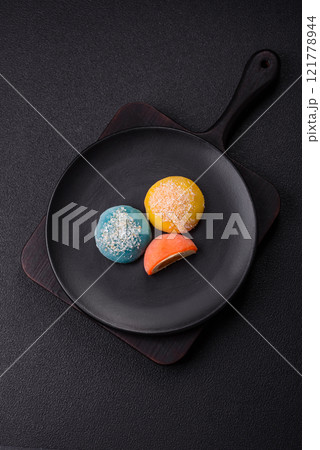 Delicious colorful asian mochi sweets with rice dough shell and fruit filling 121778944
