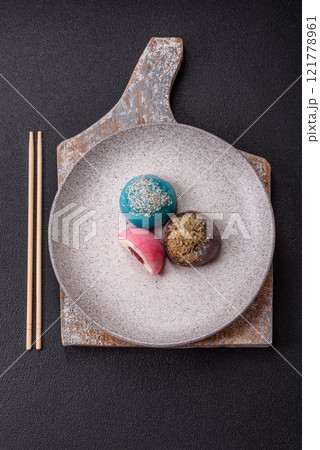 Delicious colorful asian mochi sweets with rice dough shell and fruit filling Delicious colorful asian mochi sweets with rice dough shell and fruit filling 121778961