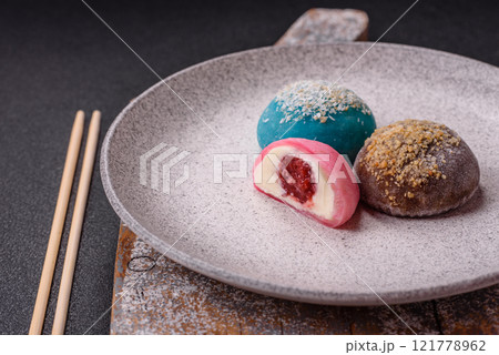 Delicious colorful asian mochi sweets with rice dough shell and fruit filling 121778962