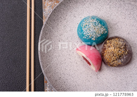 Delicious colorful asian mochi sweets with rice dough shell and fruit filling 121778963
