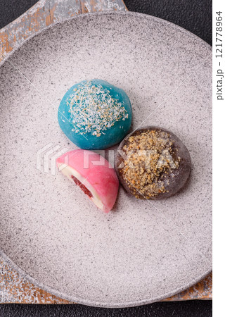 Delicious colorful asian mochi sweets with rice dough shell and fruit filling Delicious colorful asian mochi sweets with rice dough shell and fruit filling 121778964