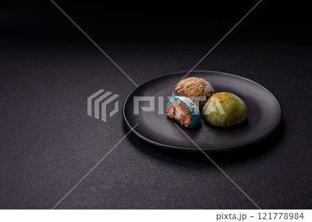 Delicious colorful asian mochi sweets with rice dough shell and fruit filling Delicious colorful asian mochi sweets with rice dough shell and fruit filling 121778984