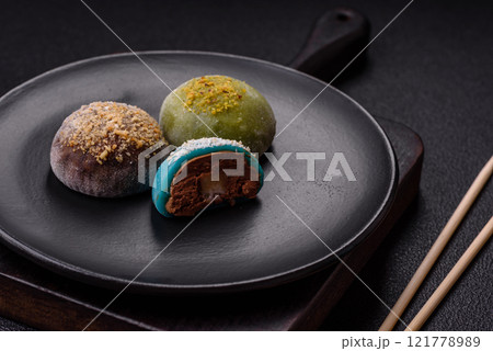 Delicious colorful asian mochi sweets with rice dough shell and fruit filling Delicious colorful asian mochi sweets with rice dough shell and fruit filling 121778989