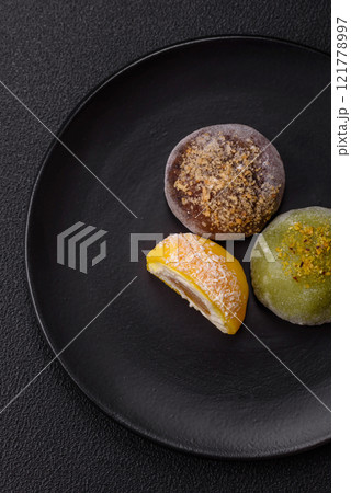 Delicious colorful asian mochi sweets with rice dough shell and fruit filling Delicious colorful asian mochi sweets with rice dough shell and fruit filling 121778997