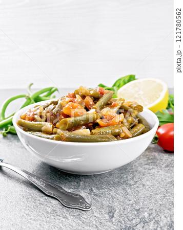 Beans green with vegetables in bowl on granite Beans green with vegetables in bowl on granite 121780562