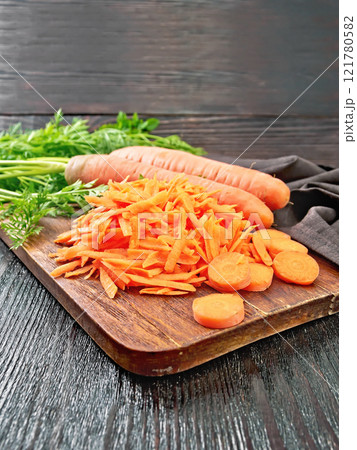 Carrots grated on black board 121780582