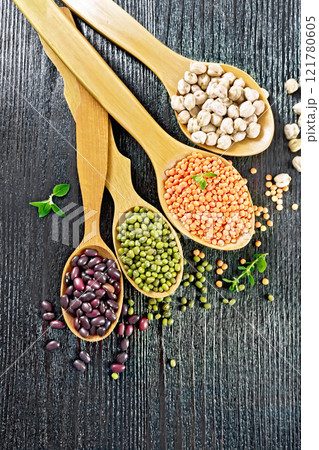 Lentils with chickpeas and beans in spoons on board top Lentils with chickpeas and beans in spoons on board top 121780605