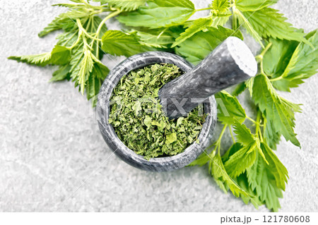 Nettle dried in mortar on stone top 121780608