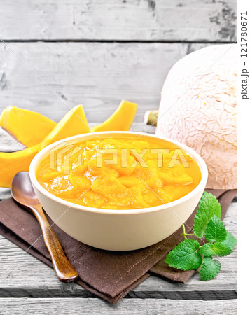 Pumpkin puree in bowl on wooden board Pumpkin puree in bowl on wooden board 121780671