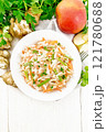 Salad of Jerusalem artichoke and apple in plate on board top 121780688