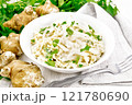 Salad of Jerusalem artichoke and eggs in plate on board 121780690