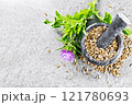 Seeds milk thistle in mortar on granite table top 121780693