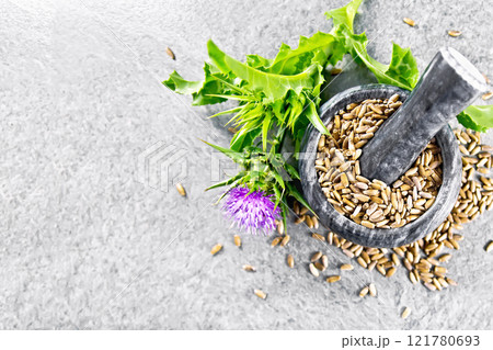 Seeds milk thistle in mortar on granite table top Seeds milk thistle in mortar on granite table top 121780693