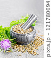 Seeds milk thistle in mortar on gray granite 121780694