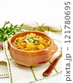 Soup-curry with pumpkin and lentils in bowl on white board 121780695