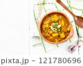 Soup-curry with pumpkin and lentils in bowl on white board top 121780696