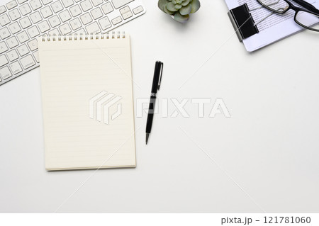 Blank notepad, document, keyboard and glasses on white working desk Blank notepad, document, keyboard and glasses on white working desk 121781060