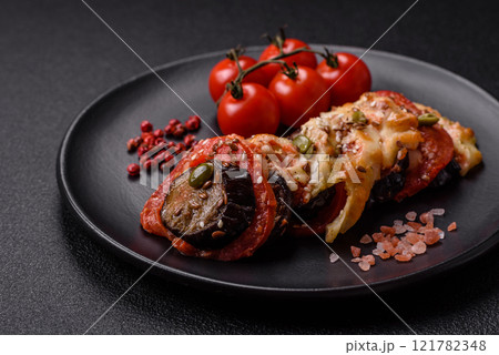 Rings of eggplant, tomato and zucchini with pieces of chicken and garlic 121782348