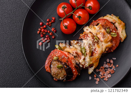 Rings of eggplant, tomato and zucchini with pieces of chicken and garlic 121782349