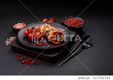Rings of eggplant, tomato and zucchini with pieces of chicken and garlic Rings of eggplant, tomato and zucchini with pieces of chicken and garlic 121782354