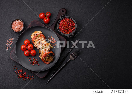 Rings of eggplant, tomato and zucchini with pieces of chicken and garlic Rings of eggplant, tomato and zucchini with pieces of chicken and garlic 121782355