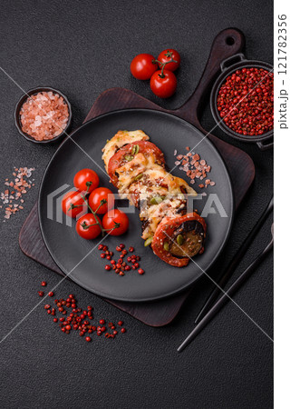 Rings of eggplant, tomato and zucchini with pieces of chicken and garlic Rings of eggplant, tomato and zucchini with pieces of chicken and garlic 121782356