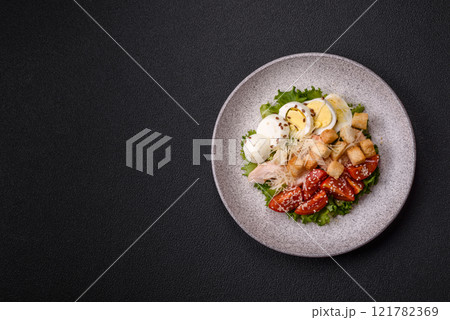 Delicious fresh salad with lettuce, croutons, chicken fillet, tomatoes and egg Delicious fresh salad with lettuce, croutons, chicken fillet, tomatoes and egg 121782369