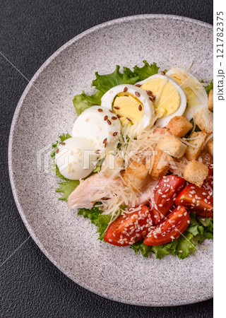 Delicious fresh salad with lettuce, croutons, chicken fillet, tomatoes and egg Delicious fresh salad with lettuce, croutons, chicken fillet, tomatoes and egg 121782375